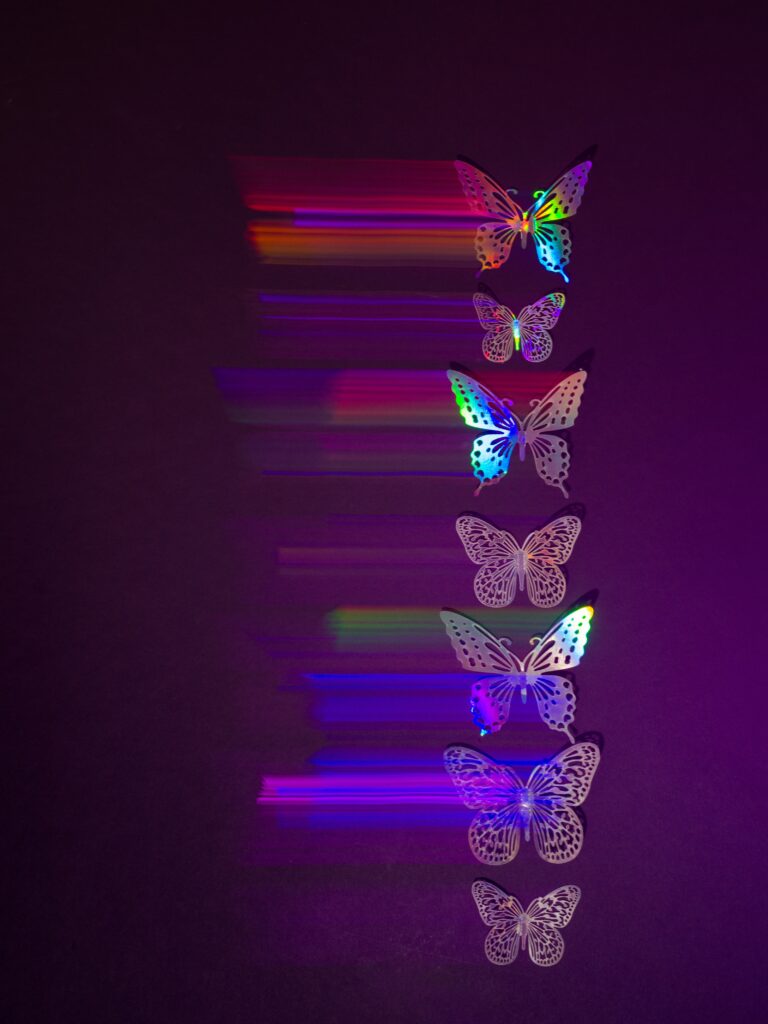 Butterflies stacked like energies, each with a techno color pattern.