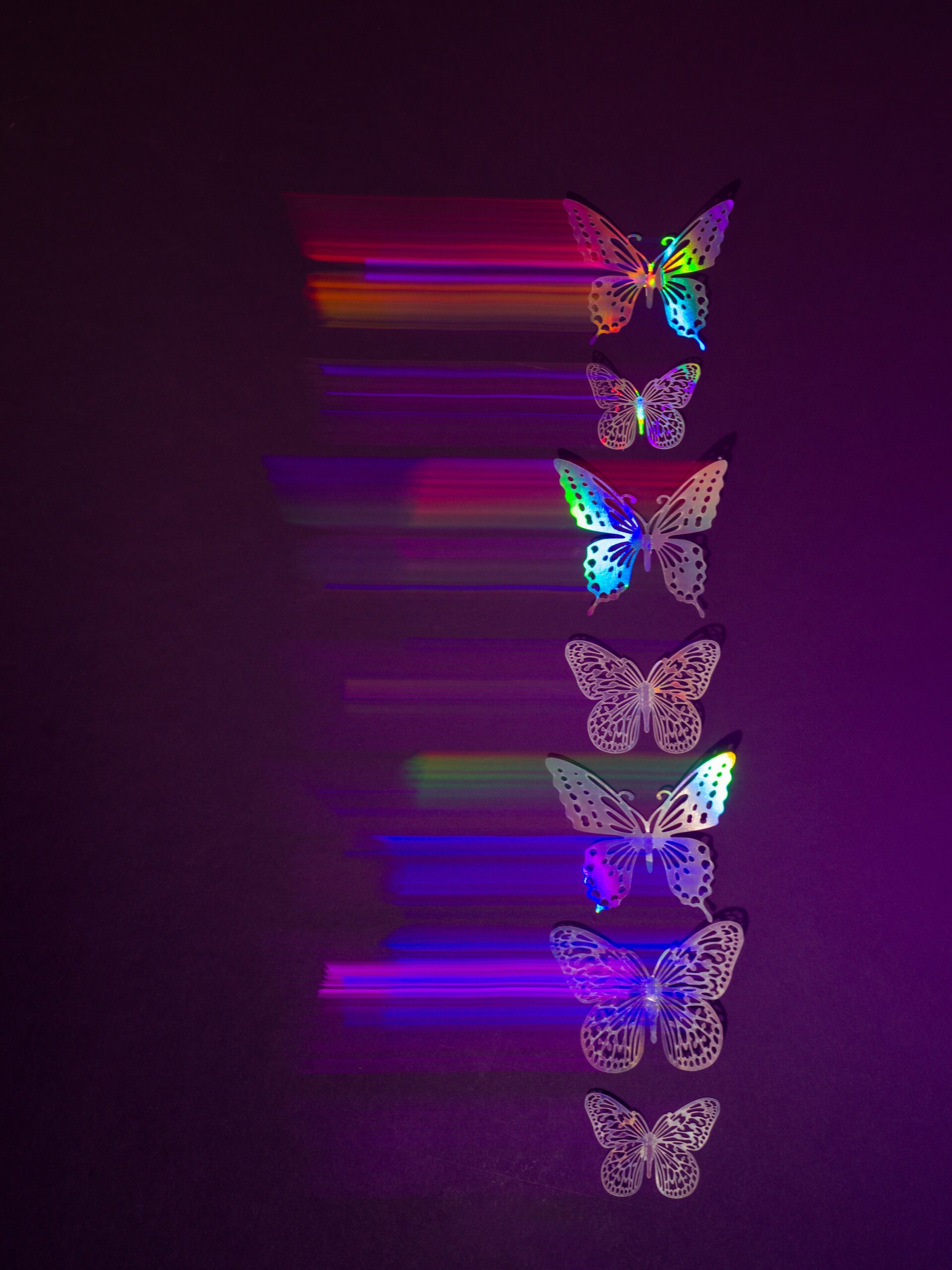 Butterflies stacked like energies, each with a techno color pattern.